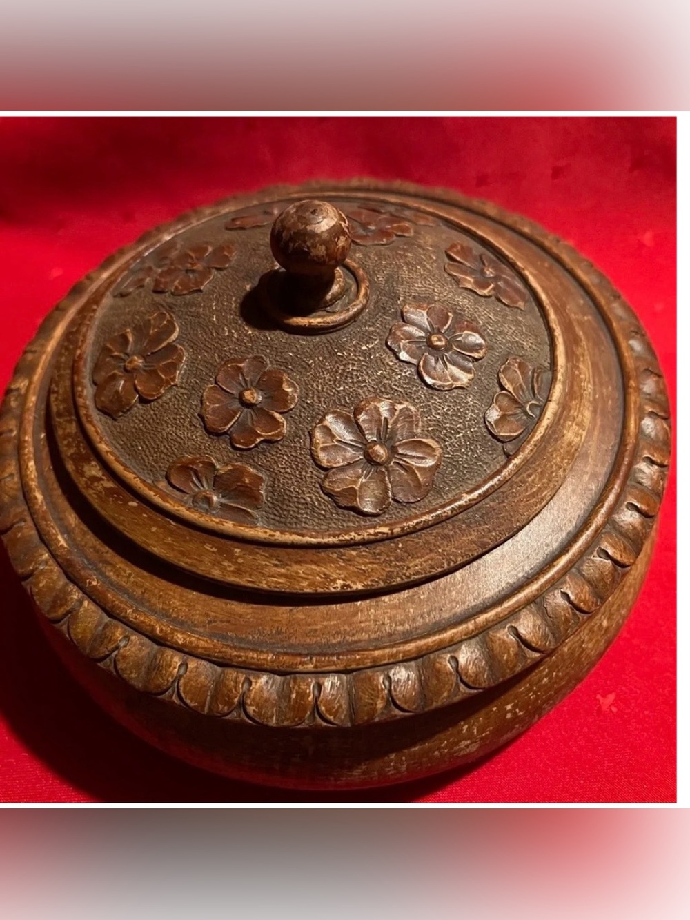 A vintage, hand-carved wooden box with a lid